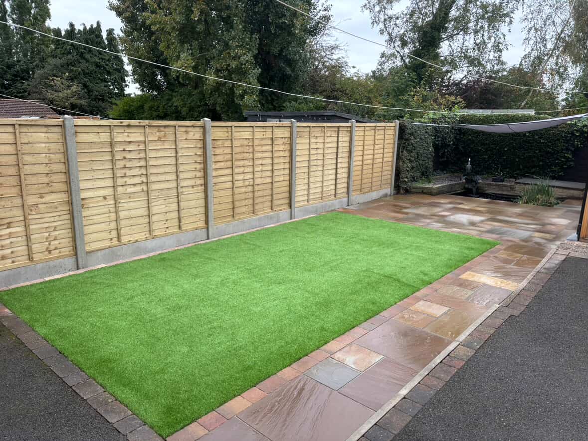 Artificial grass laid alongside a sandstone path in a Derby garden
