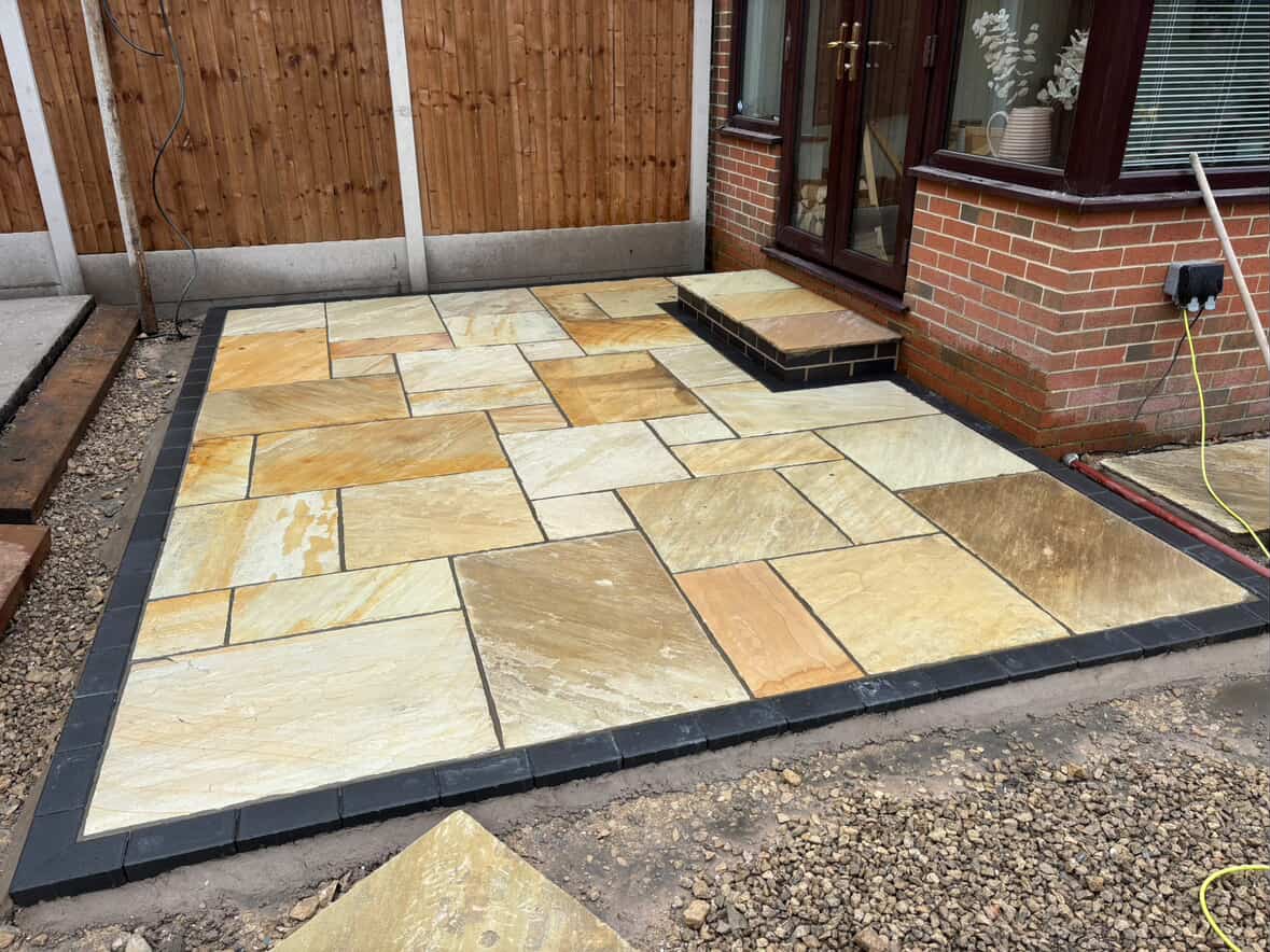 Indian sandstone patio with granite sett border, cleaned and ready to seal
