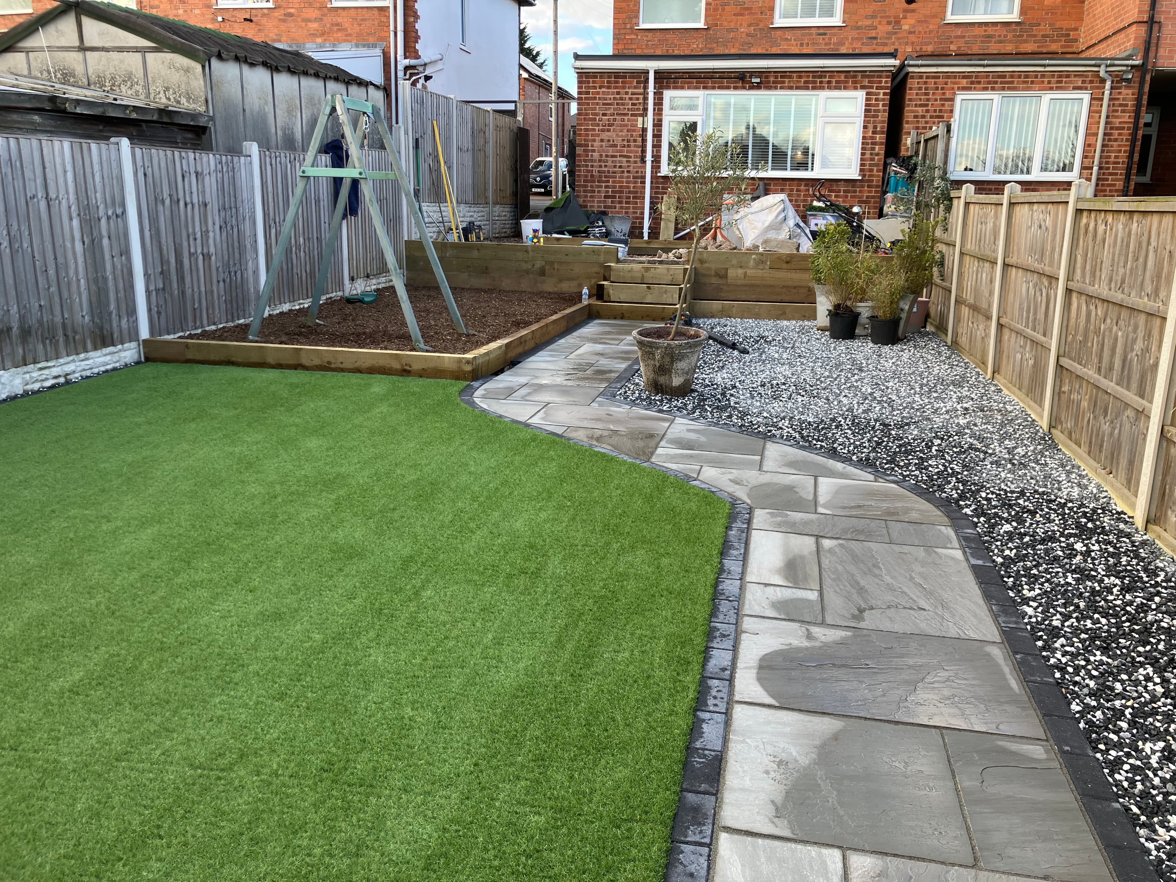 Timber railway sleeper raised flower beds built along the garden boundary