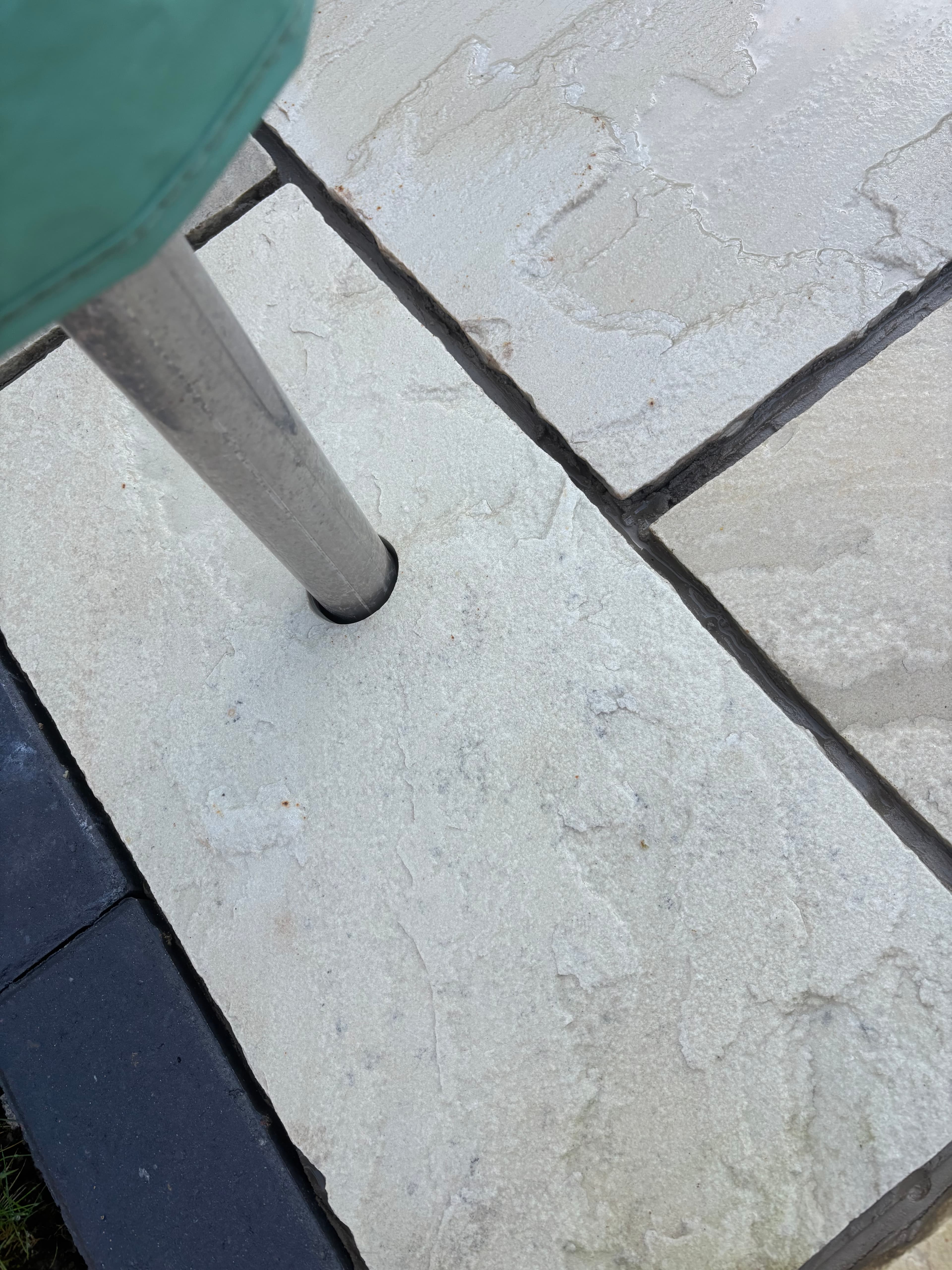 Charcoal paver picture frame detail around the main sandstone patio