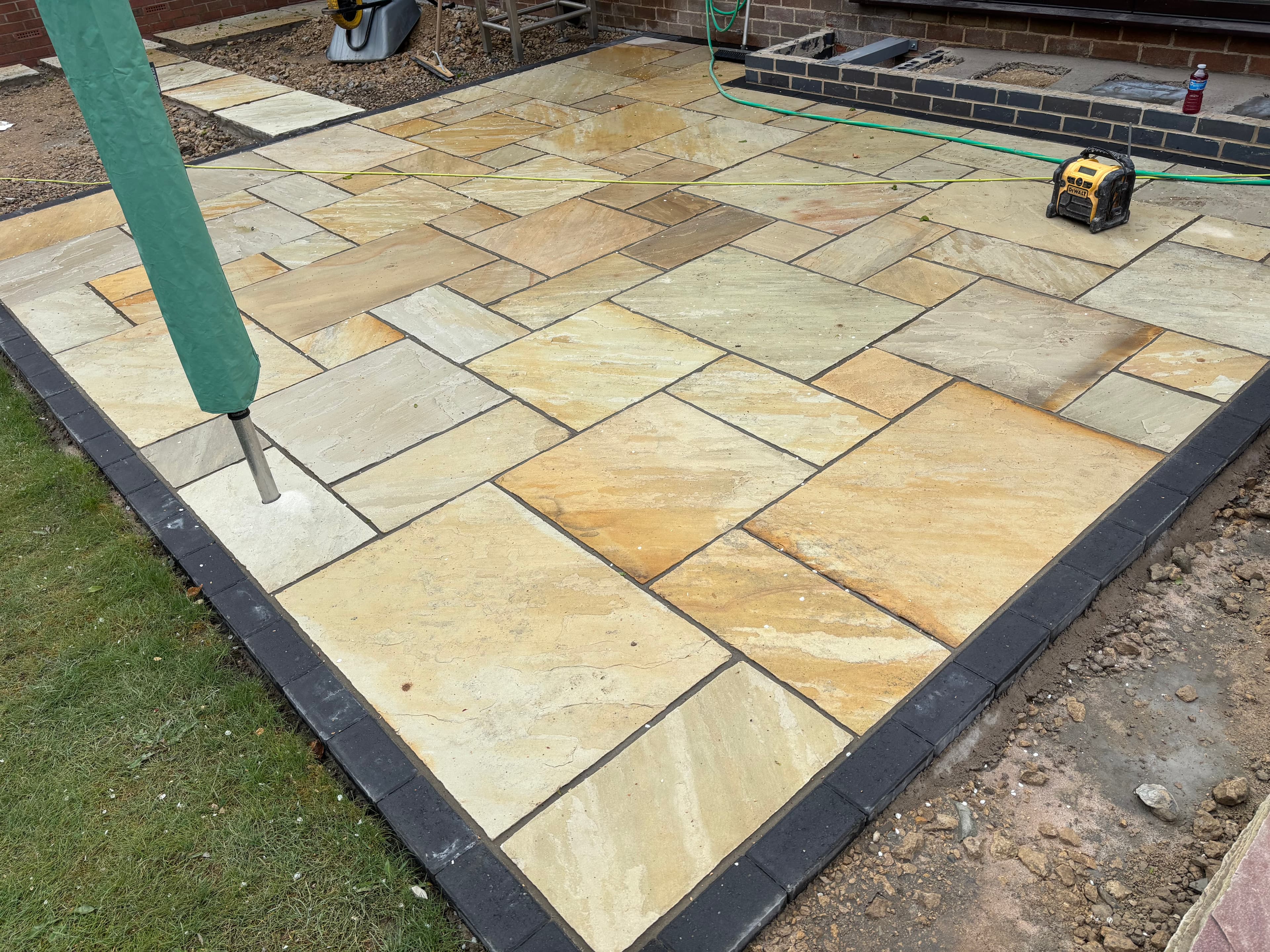Side patio area with moonstone gravel surround and stepping stone access