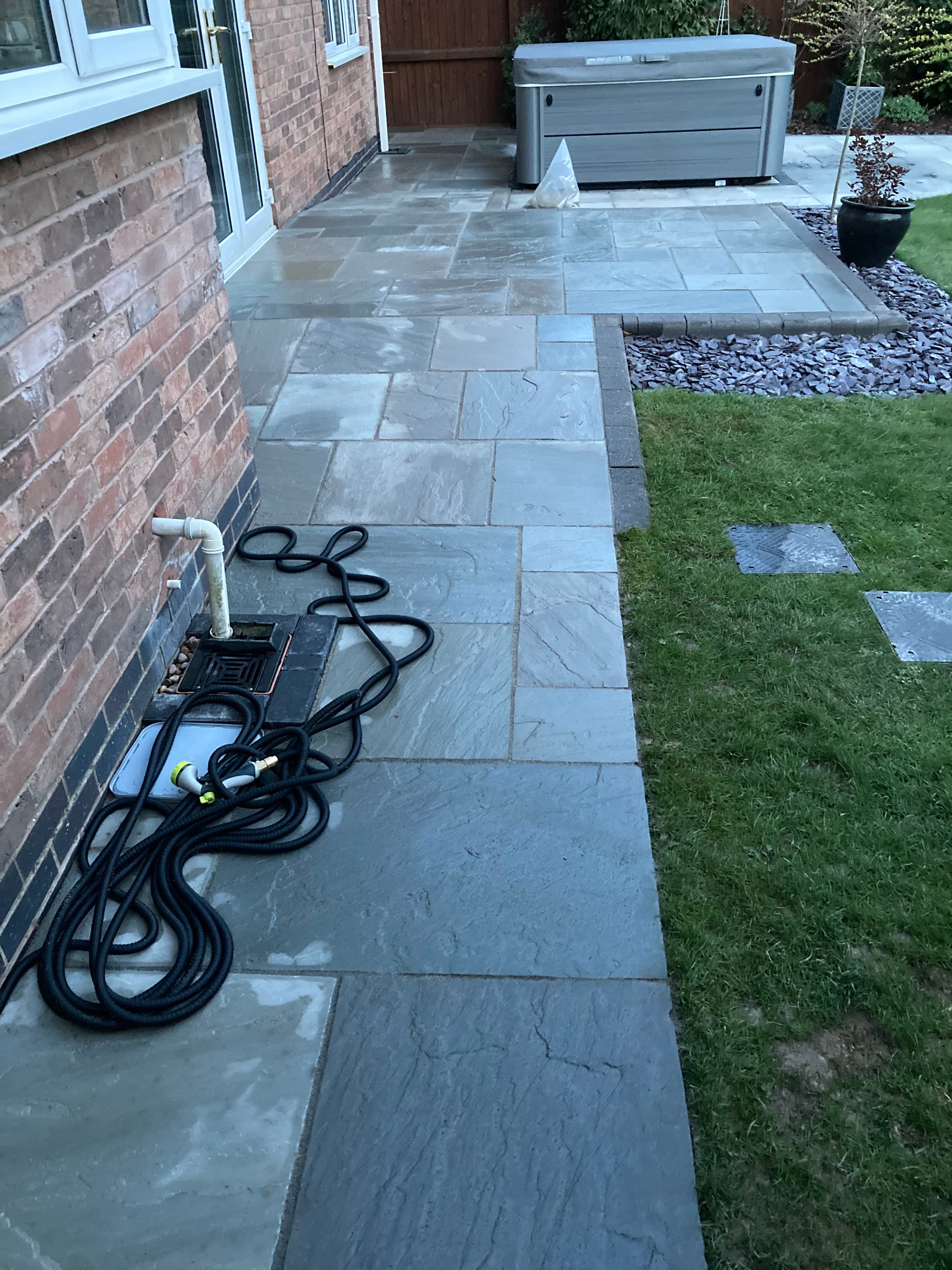 New patio section joining seamlessly with the existing patio around the property