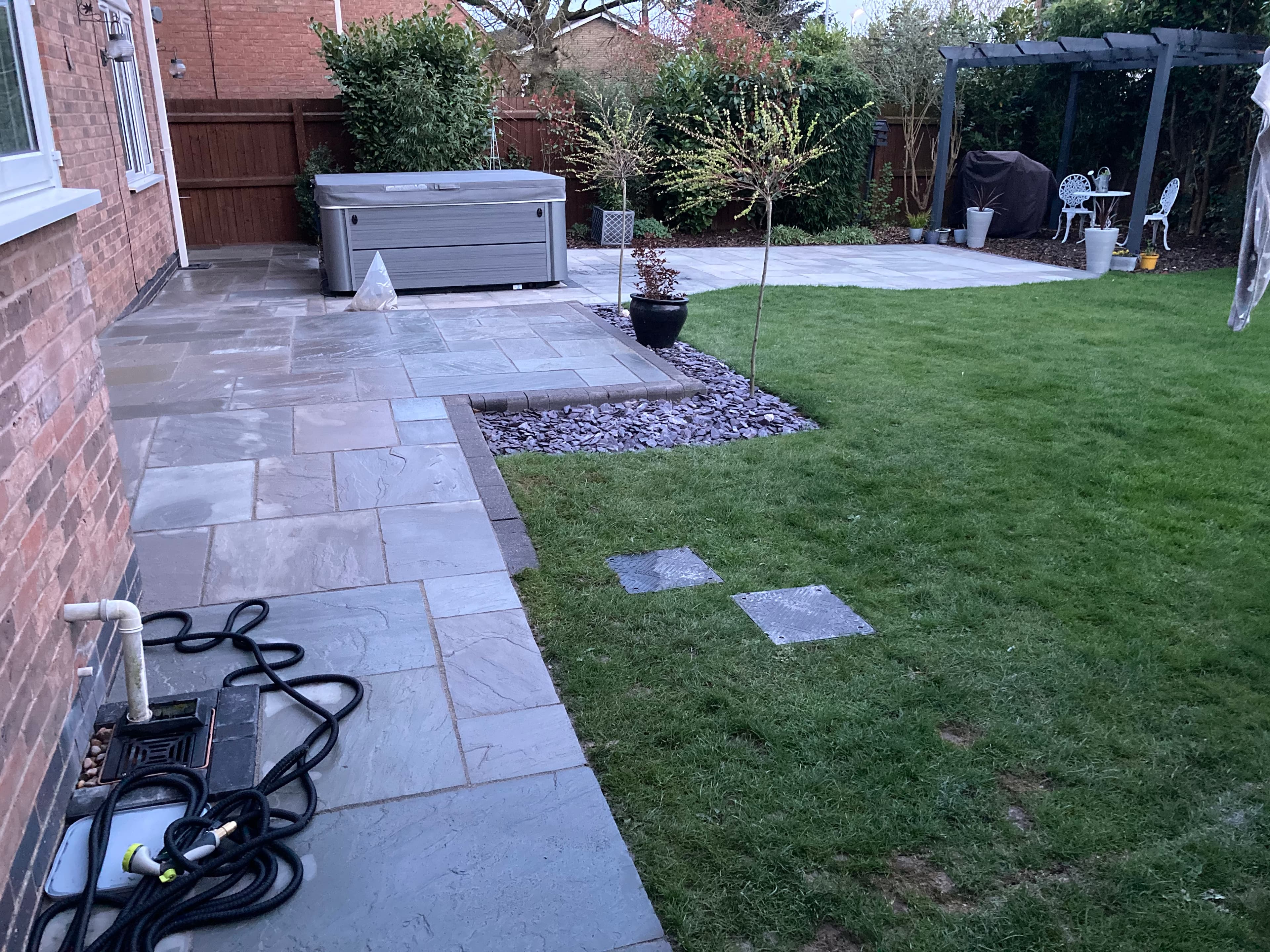 Completed continuous patio wrapping around the full perimeter of the house