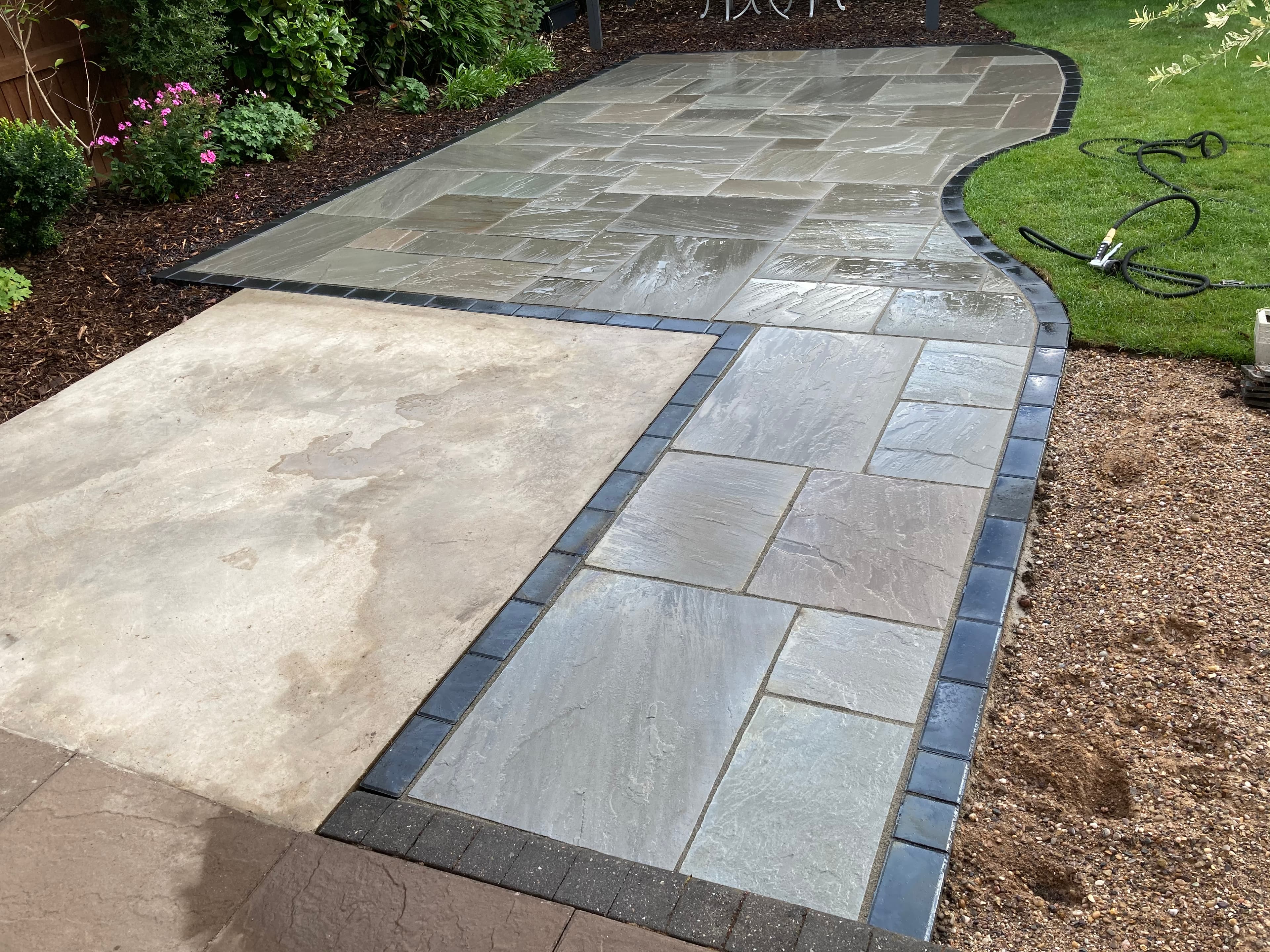 Natural stone patio flowing into the surrounding garden in Burton upon Trent