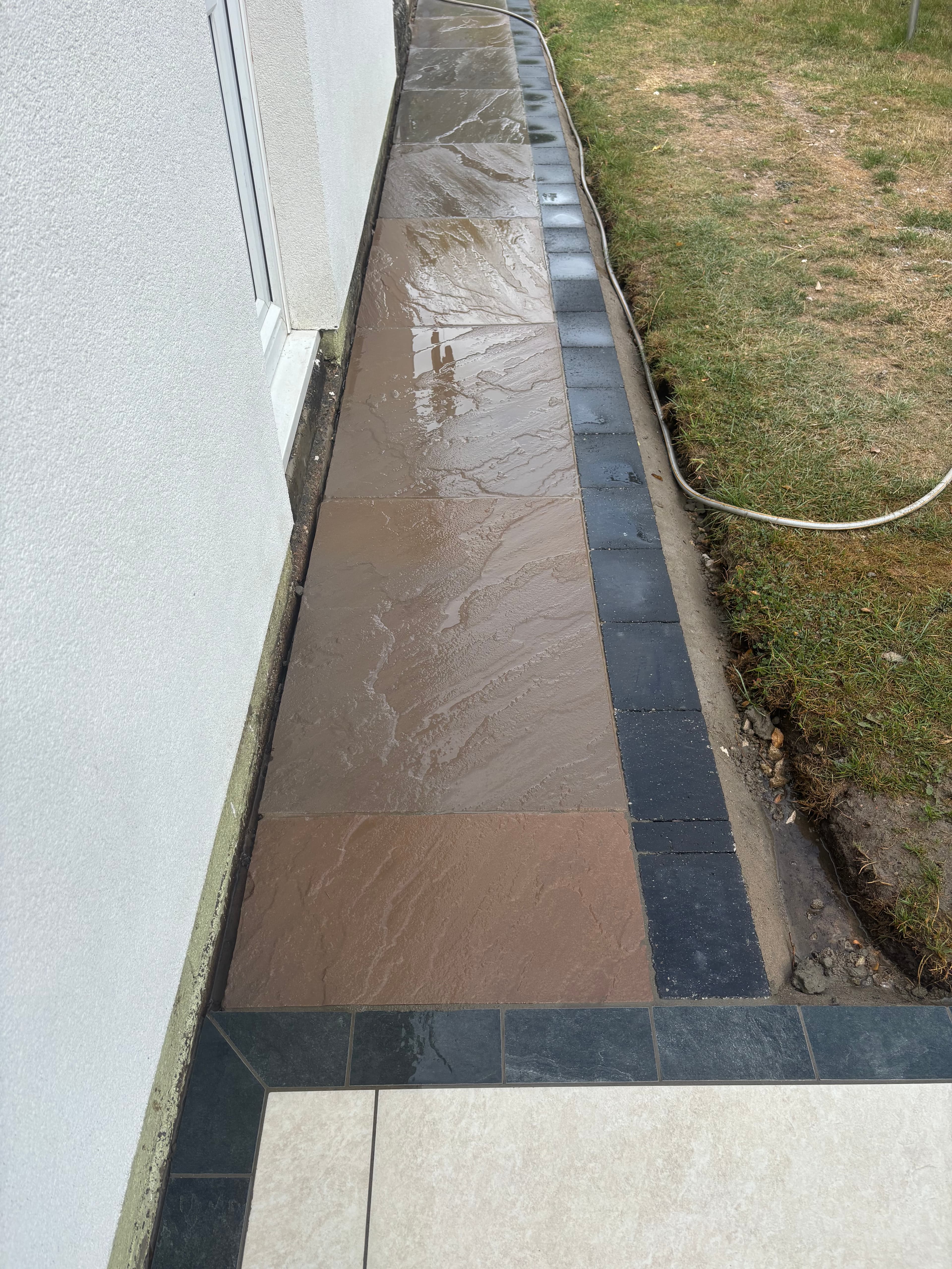 Full rear garden patio installation in Derby with anthracite border detail