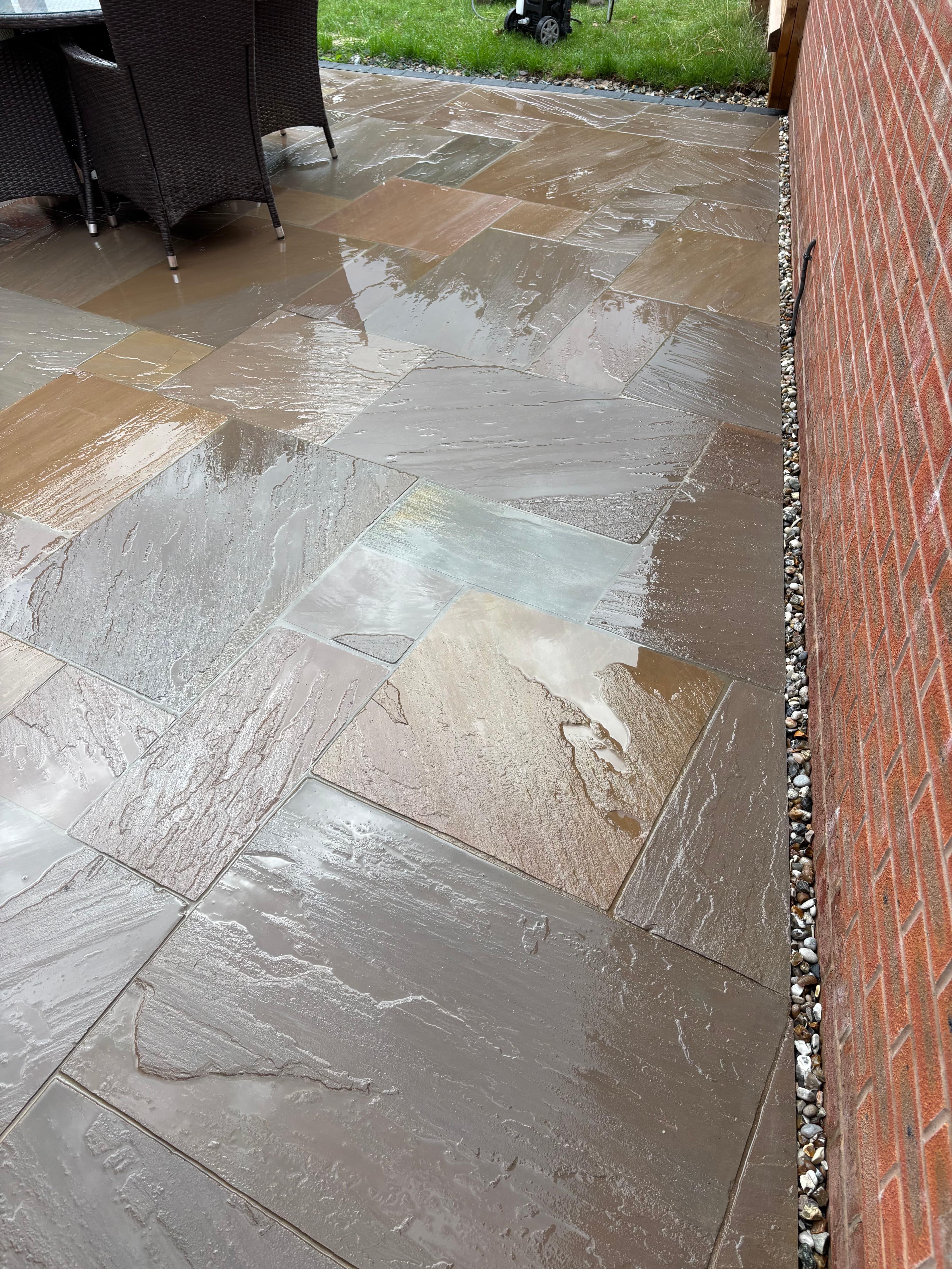 Paving laid around the house perimeter with charcoal paver border