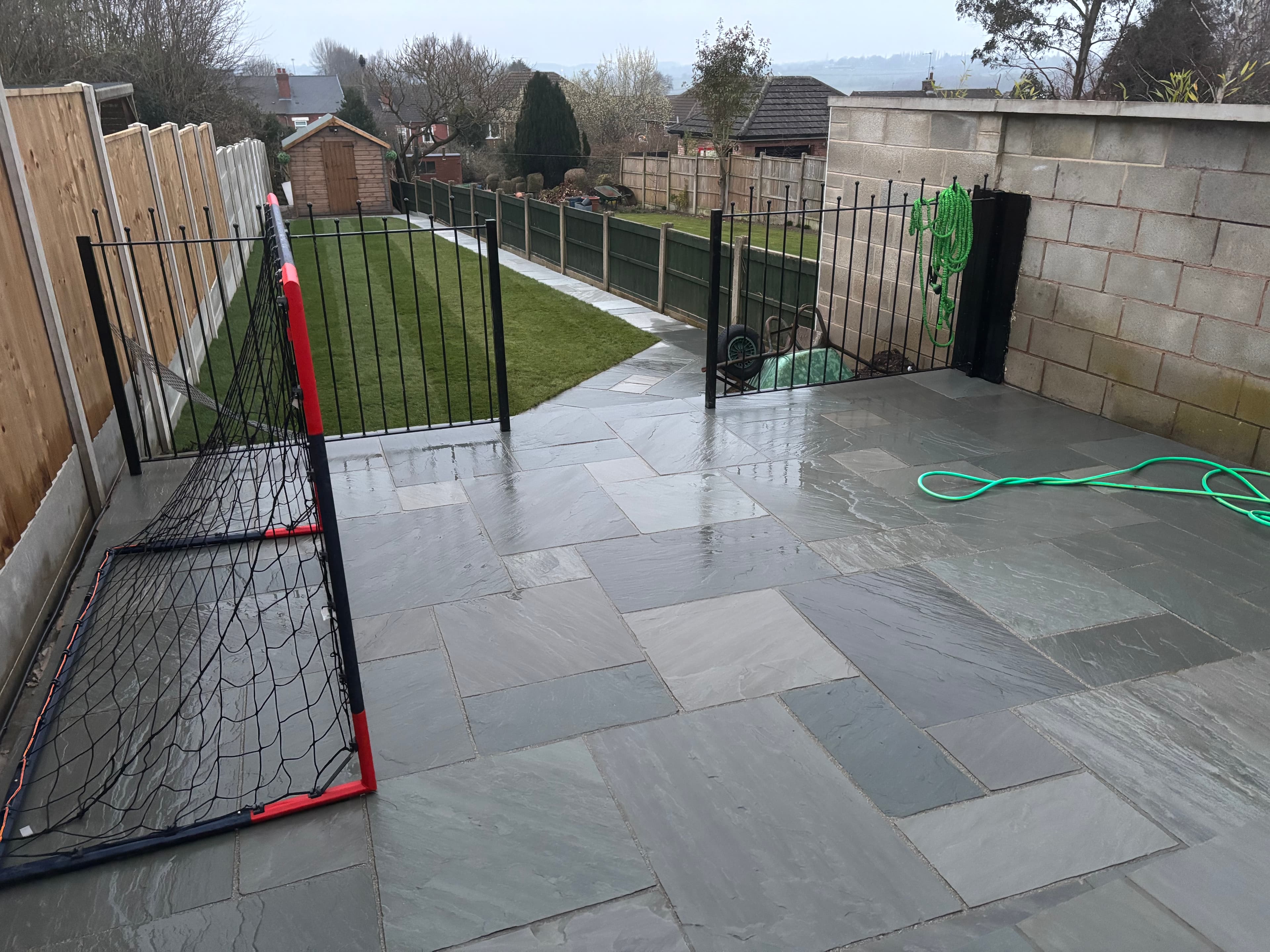 Sandstone path leading from the patio across the rear garden