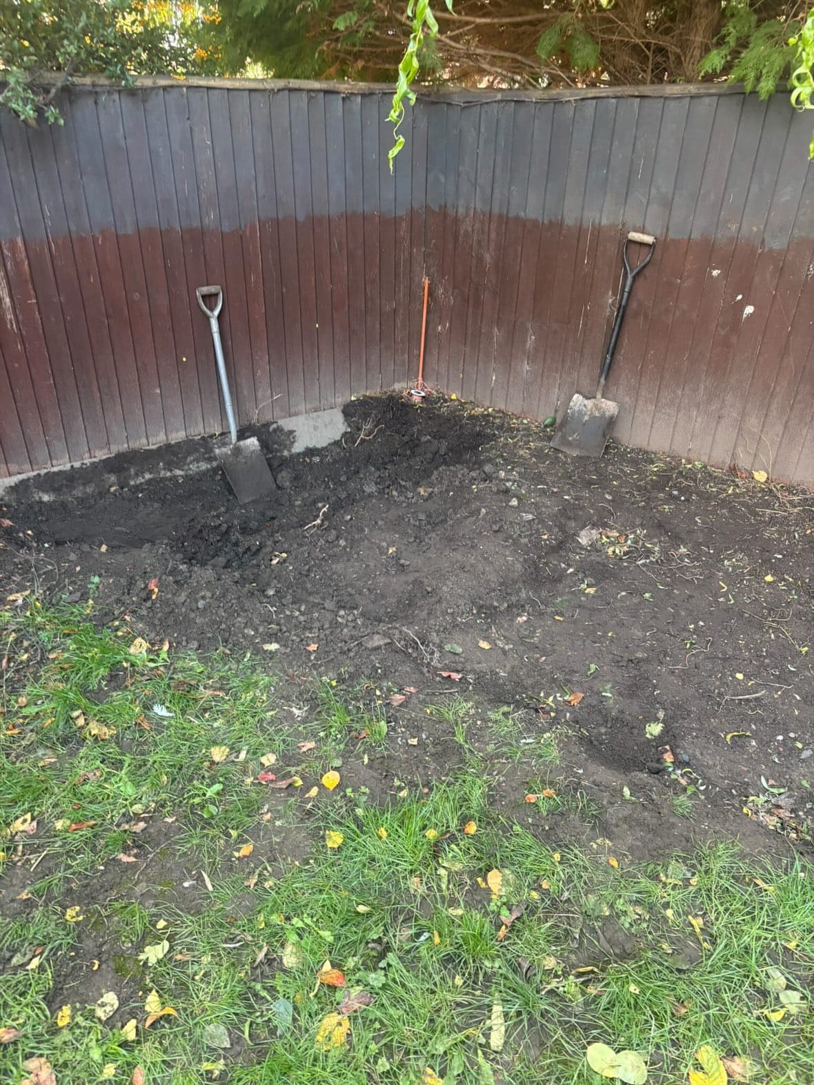 Excavation of a sunken patio area with a new retaining wall in progress
